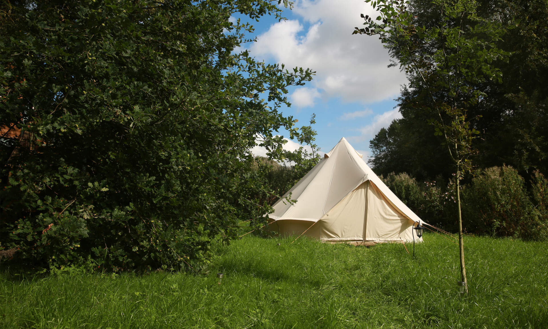 A bell tent in the woods at the Camp Nothing event.