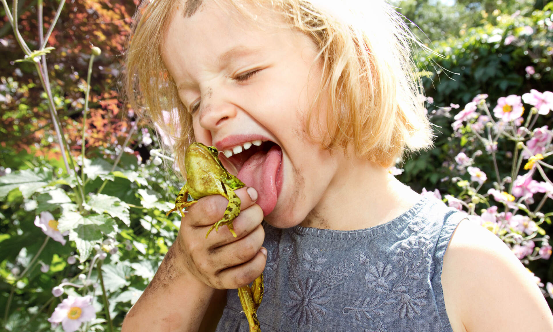 The Wild Network brand photography — a girl licking a frog.