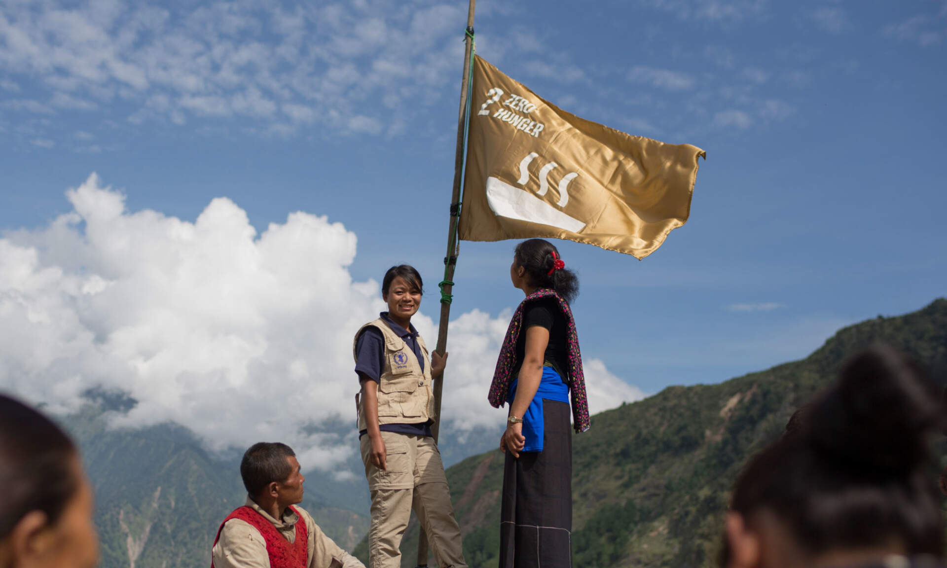People holding up a large flag showing the Zero Hunger goal from the Global Goals campaign.